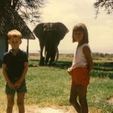 #ThrowbackThursday - Amboseli was a favourite destination for Joyce’s family when growing up in Kenya in the 1960s. On school holidays her family drove from Nairobi and camped there under the shade of the yellow fever trees. Pictured here is her brother, Bob, (@bobpoolefilms) and Joyce with the famous elephant, Odinga, in the background. This photograph was taken in about 1967 at the so-called 