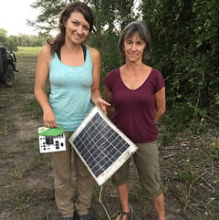 Scientist, Jen Guyton, and Joyce contemplate why an elephant might have decided to destroy solar equipment used to power Jen's motion triggered camera. ©ElephantVoices.
